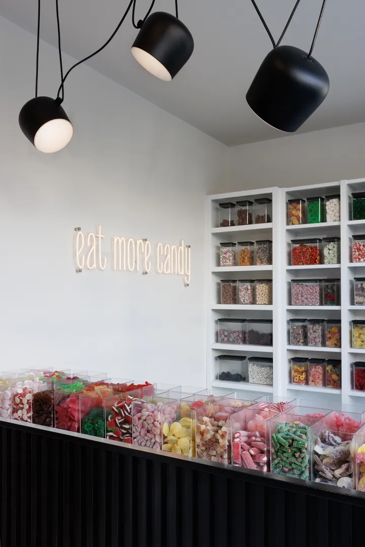 Karameller Candy Store — candy bins with neon sign